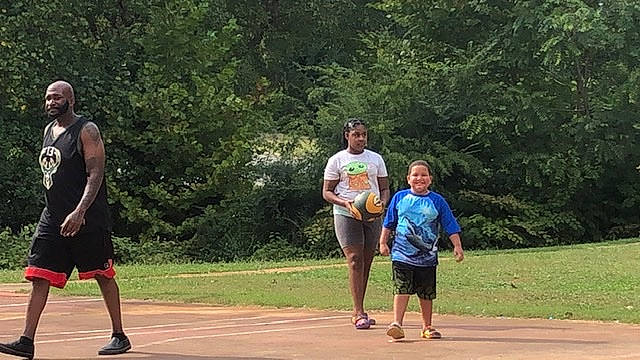 Jared is registered to the contest to win money with this photo: athlete, community, competition_event, event, footwear, fun, grass, joy, leisure, luggage_and_bags, person, plant, player, recreation, shoe, shorts, sneakers, sports, sports_equipment, summer