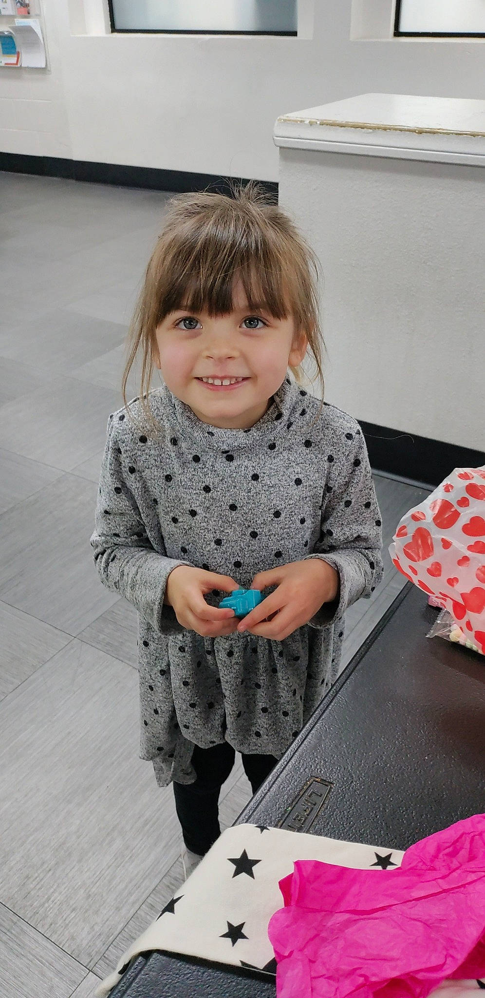 Anastasia is registered to the contest to win money with this photo: baby_toddler_clothing, beauty, black, carmine, child, dress, flooring, fun, gadget, hair, happy, holiday, human_body, joy, pattern, person, room, sitting, sleeve, smile