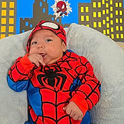 Oliver joined the competition — help win amazing prizes! baby, child, costume, spiderman, red, blue, couch, cushion, soft, indoor, portrait, face, hand, fingers, cityscape, cartoon, superhero, cute, smiling, infant