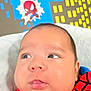 Oliver joined the competition — help win amazing prizes! baby, child, infant, spiderman_outfit, red_clothing, black_stripes, face, cheeks, blue_eyes, background, comic_style, cartoon, pow_text, buildings, wall_art, curious_expression, portrait, indoor, soft_light, close_up