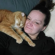 Chevy is registered to the contest to win money with this photo: person, cat, orange_cat, pet, bed, pillow, blanket, bedding, selfie, lying_down, snuggling, fur, hair, black_clothing, nose_piercing, indoor, close_up, relaxed, sleeping, affectionate