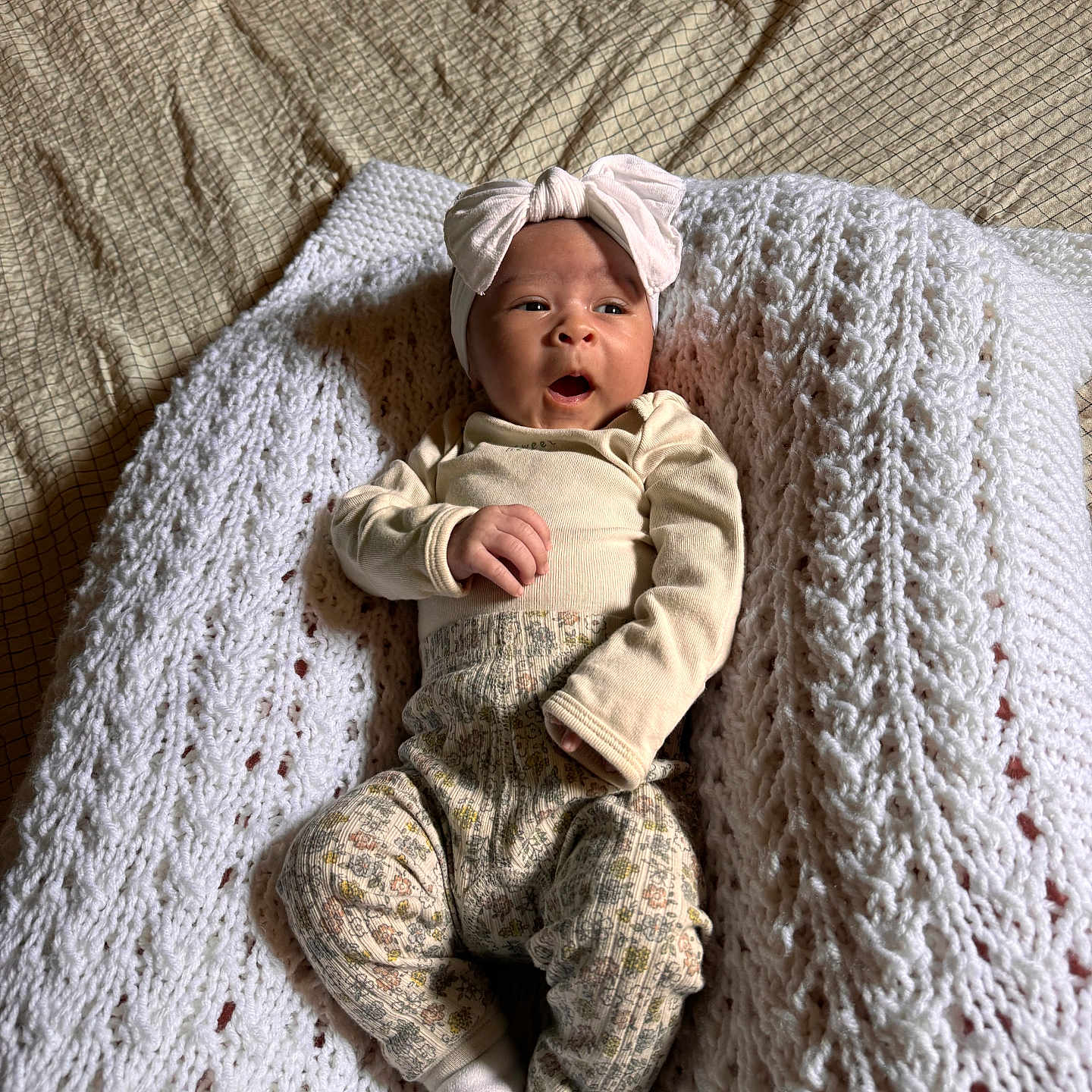 Emory is registered to the contest to win money with this photo: baby, bed, blanket, bonnet, cap, clothing, couch, face, furniture, happy, hat, head, knitwear, newborn, person, photography, portrait, sleeping, smile, yawning