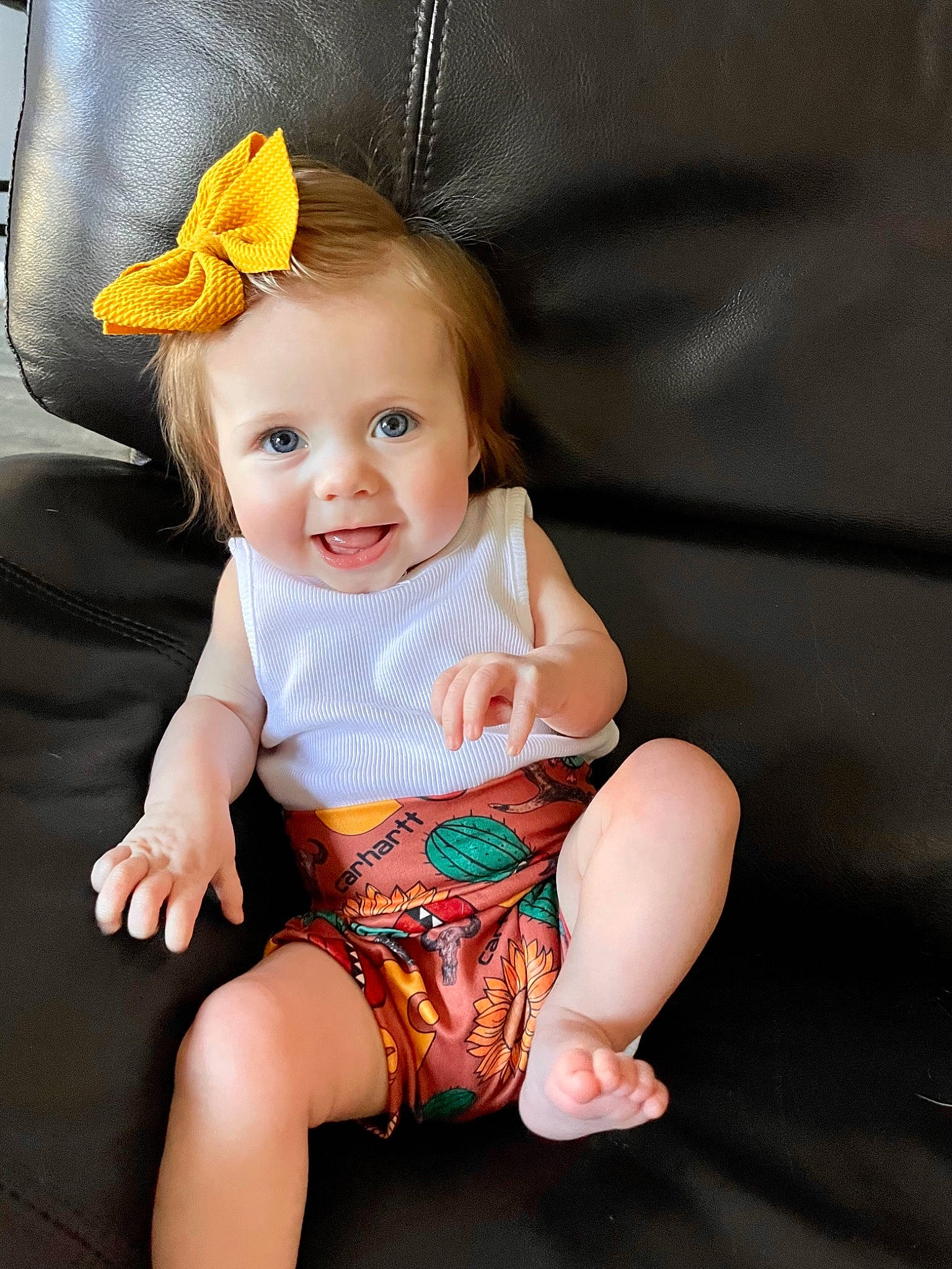 Charley is registered to the contest to win money with this photo: arm, baby, baby_toddler_clothing, cheek, chin, comfort, eye, face, finger, hand, happy, hat, head, iris, leg, person, skin, sleeve, smile, thigh