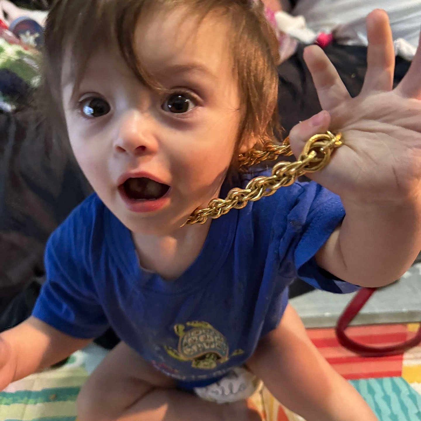 Steven is registered to the contest to win money with this photo: accessories, baby, bodypart, bracelet, clothing, crawling, eating, face, finger, food, hand, head, jewelry, necklace, person, photography, portrait, sitting, surprised, t_shirt