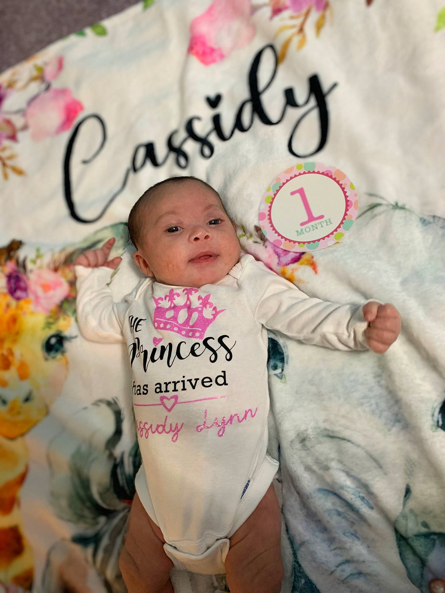 Cassidy is registered to the contest to win money with this photo: baby, baby_products, baby_toddler_clothing, cheek, child, event, font, handwriting, happy, head, linens, magenta, person, photo_caption, pink, room, sleeve, smile, sweetness, t_shirt