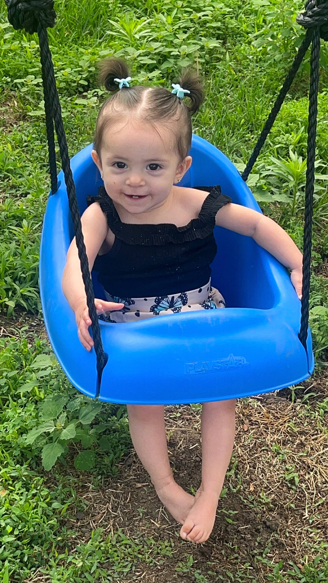 Melanie is registered to the contest to win money with this photo: baby_toddler_clothing, beauty, blue, child, electric_blue, eye, fun, grass, happy, joy, leisure, outdoor_play_equipment, people_in_nature, person, plant, recreation, smile, summer, swing, thigh