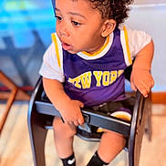 Yetxiel joined the competition — help win amazing prizes! toddler, child, curly_hair, high_chair, purple_clothing, new_york, socks, nike, indoor, wooden_floor, black_chair, curious, seated, baby, cute, portrait, expression, hands, looking_away, young_child