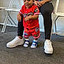 Yetxiel joined the competition — help win amazing prizes! toddler, child, person, red_clothing, sportswear, blue_sandals, white_sneakers, black_leggings, carpet, indoor, folding_chairs, smiling, standing, support, adult, casual, happy, shorts, portrait, room