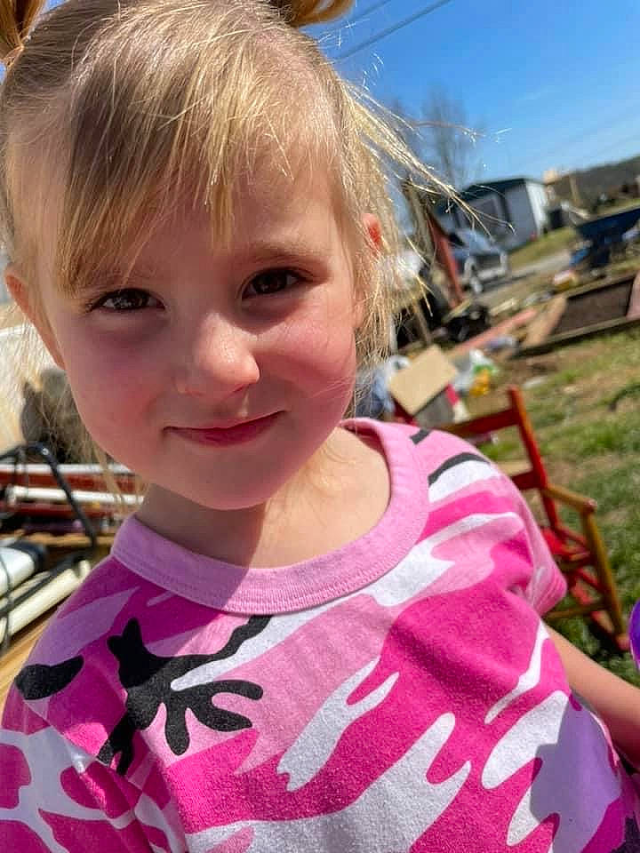 Aubree is registered to the contest to win money with this photo: cheek, child, chin, cool, facial_expression, fun, grass, hairstyle, happy, iris, joy, leisure, lip, nose, person, pink, skin, sky, smile, t_shirt