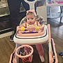 Mya is registered to the contest to win money with this photo: baby, walker, indoor, floor, toy, basketball_hoop, child, person, adult, headband, pink, play, furniture, footwear, hand, tattoo, window, cabinet, flooring, curious