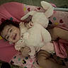 baby, baby_seat, bunny, child, clothing, cute, fabric, happy, hearts, indoor, infant, pattern, person, pink, playful, seat, smiling, stars, stuffed_toy, toy