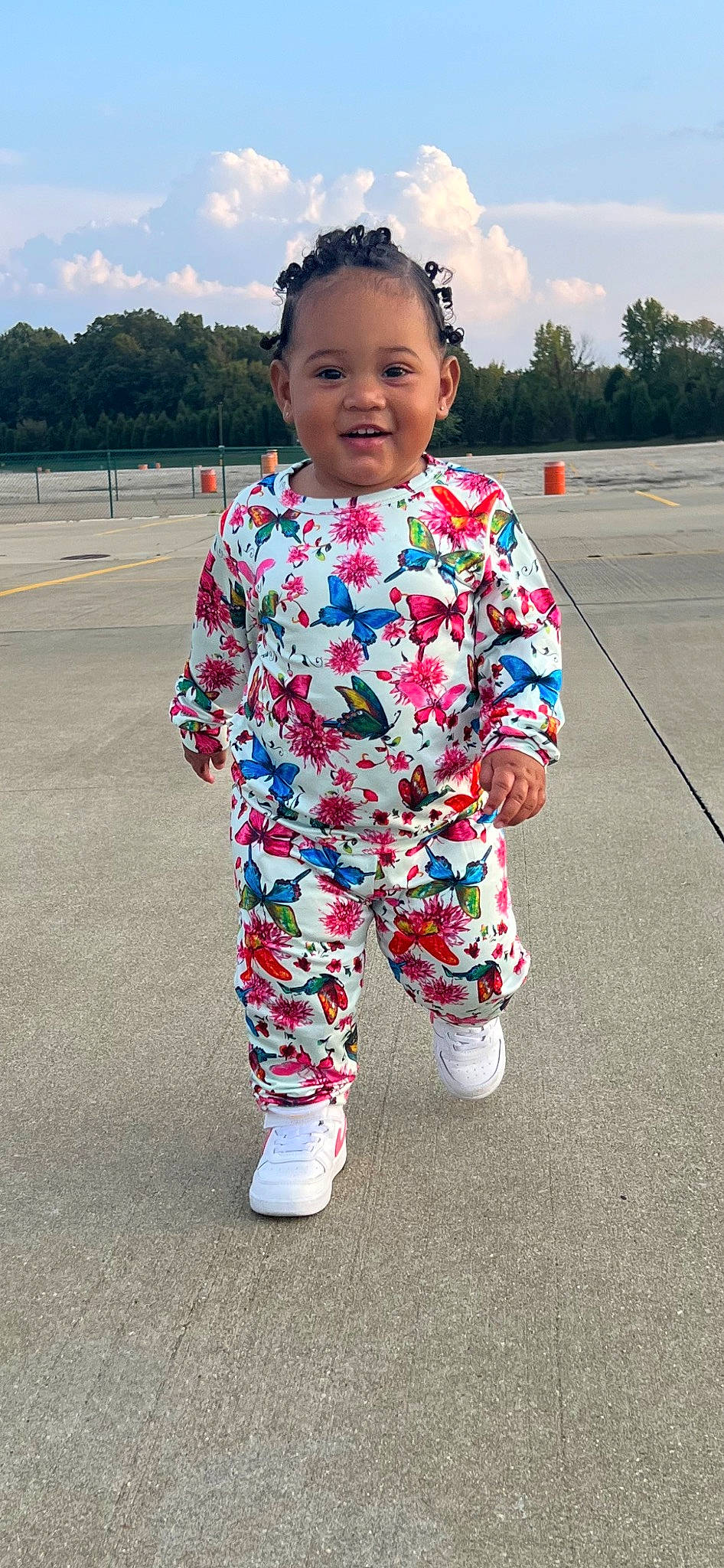 Sirena is registered to the contest to win money with this photo: asphalt, baby_toddler_clothing, child, cloud, cool, electric_blue, fun, grass, happy, head, joy, magenta, pattern, person, pink, sky, sleeve, smile, t_shirt, toddler