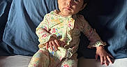 Alice joined the competition — help win amazing prizes! baby, child, infant, portrait, sitting, lying_down, floral_outfit, onesie, blue_pillow, bed, bedroom, wooden_headboard, indoors, face, eyes, wide_eyed, calm, clothing, natural_light, photography