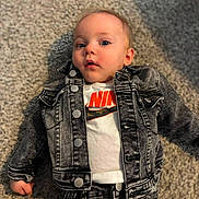 Jaxon joined the competition — help win amazing prizes! baby, infant, child, portrait, lying_down, carpet, denim_jacket, jeans, clothing, nike, fashion, casual, indoor, floor, face, blue_eyes, looking_at_camera, serious_expression, photography, full_body