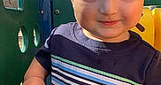Wesson is registered to the contest to win money with this photo: toddler, child, playground, outdoor, sunlight, blue_sky, plastic_play_equipment, smile, short_sleeve_shirt, striped_shirt, person, daylight, young_child, hand, face, happy, nature, recreation, casual_clothing, cute