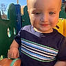 toddler, child, playground, outdoor, sunlight, blue_sky, plastic_play_equipment, smile, short_sleeve_shirt, striped_shirt, person, daylight, young_child, hand, face, happy, nature, recreation, casual_clothing, cute