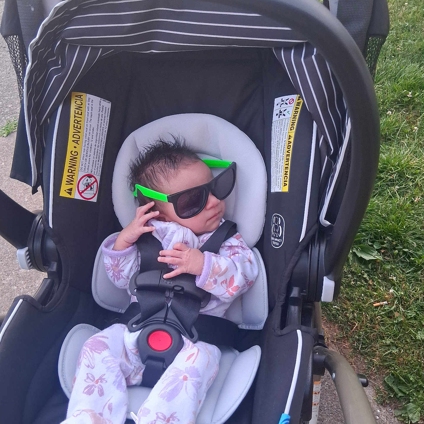 Infinitee joined the competition — help win amazing prizes! baby, infant, car_seat, sunglasses, green, outdoor, grass, sidewalk, clothing, onesie, safety_harness, cute, person, head, hair, hand, footwear, fashion, child, accessory
