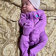 Ashanda joined the competition — help win amazing prizes! baby, sleeping, onesie, hat, purple_clothing, blanket, paisley_pattern, infant, cozy, peaceful, bedtime, face, child, portrait, soft, cute, newborn, resting, warm, indoors