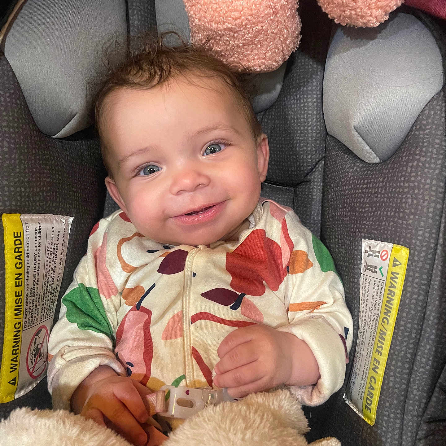 Ashanda is registered to the contest to win money with this photo: baby, car_seat, child, clothing, colorful_clothing, cute, fabric, face, hand, happy, head, indoor, infant, person, portrait, seat_belt, smiling, soft_toy, stuffed_toy, young_child