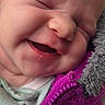 newborn, baby, infant, sleeping, yawning, face, portrait, close_up, fuzzy_collar, purple_clothing, jacket, blanket, cozy, indoors, head, eyes_closed, nose, mouth, skin, candid