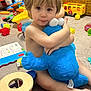 Asher is registered to the contest to win money with this photo: bodypart, boy, bus, child, clothing, face, finger, footwear, hand, head, indoors, male, person, photography, plush, portrait, shoe, toy, transportation, vehicle