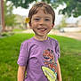 Joshua joined the competition — help win amazing prizes! child, boy, smiling, flower, purple_tshirt, dinosaur_graphic, outdoor, grass, tree, portrait, happy, freckles, short_hair, casual_clothing, nature, daylight, cute, young, person, greenery