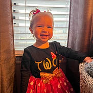 Avery is registered to the contest to win money with this photo: child, toddler, smile, dress, polka_dot, bow, hair_bows, window, blinds, curtains, indoor, lighting, happy, person, clothing, face, portrait, standing, cheerful, cute