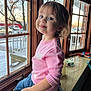 Avery is registered to the contest to win money with this photo: toddler, child, pink_sweater, jeans, windowsill, indoor, window, snow, playful, smile, portrait, person, young_child, wooden_frame, cozy, casual_clothing, daylight, home_interior, cute, funny_expression
