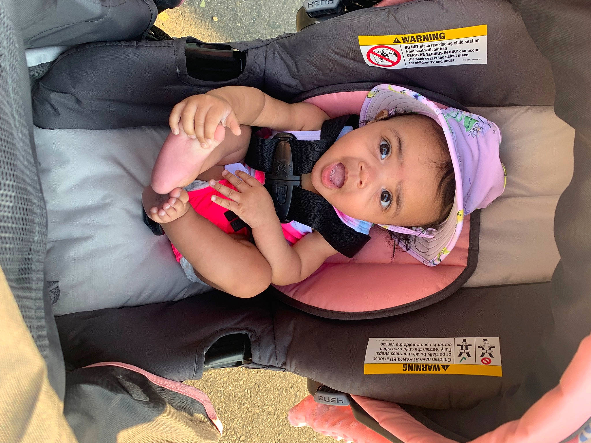 Marlani is registered to the contest to win money with this photo: baby, baby_products, car_seat, child, comfort, couch, fun, hand, happy, hat, human_leg, lap, mouth, nail, person, room, sitting, surprise, thigh, thumb