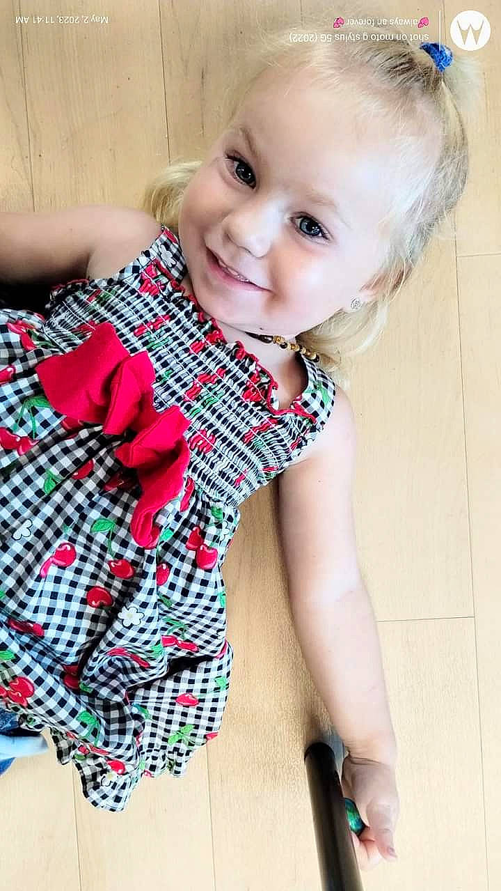 Audrey is registered to the contest to win money with this photo: arm, baby_toddler_clothing, collar, elbow, eye, face, finger, happy, head, joy, neck, pattern, person, plaid, shoulder, skin, sleeve, smile, tartan, thigh