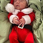 Wyatt is registered to the contest to win money with this photo: baby, sleeping, santa_claus_costume, red_clothing, white_fur_trim, black_belt, blanket, green_blanket, infant, cute, holiday, christmas, festive, newborn, soft_texture, hands, face, headwear, nap, cozy
