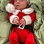 baby, sleeping, santa_claus_costume, red_clothing, white_fur_trim, black_belt, blanket, green_blanket, infant, cute, holiday, christmas, festive, newborn, soft_texture, hands, face, headwear, nap, cozy