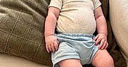 Cole is registered to the contest to win money with this photo: arms, baby, child, clothing, comfort, couch, cushion, face, happy, home, indoors, infant, legs, portrait, relaxing, seated, shirt, shorts, skin, smile