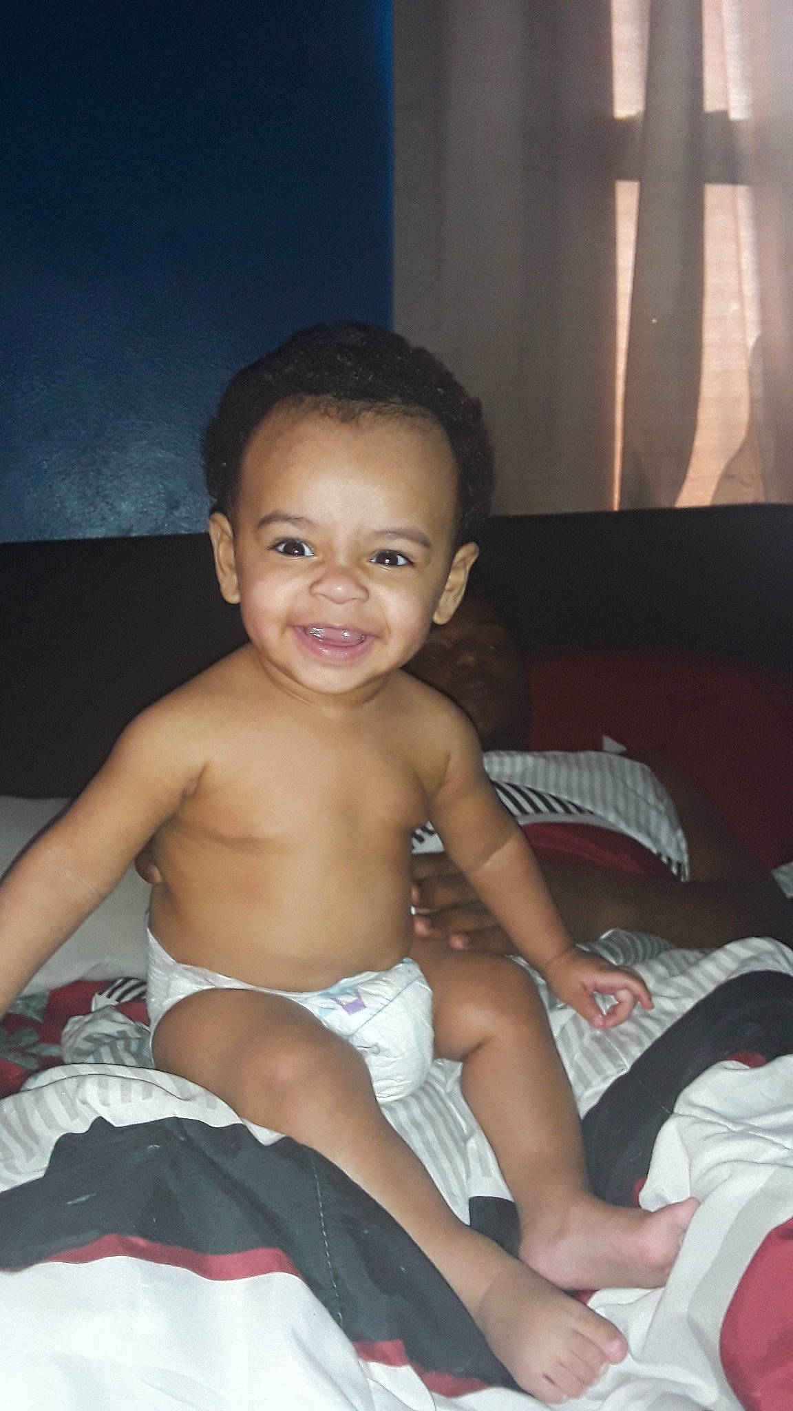 D'Andre is registered to the contest to win money with this photo: arm, baby, black_hair, cheek, chest, child, eye, fun, joy, leg, male, muscle, person, sitting, skin, smile, thigh, toddler, vacation