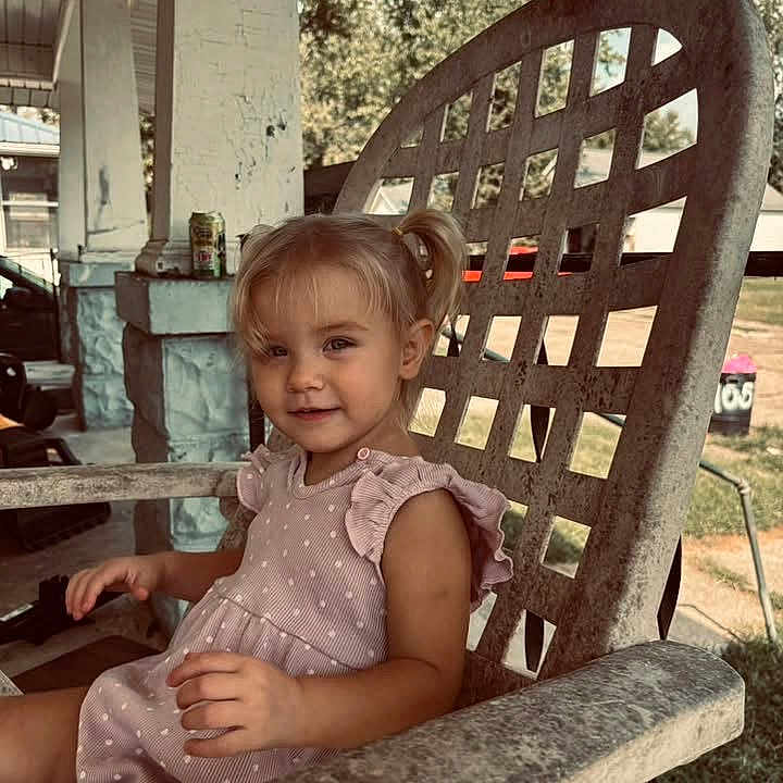 Victoria joined the competition — help win amazing prizes! child, toddler, girl, portrait, smiling, sitting, outdoor, porch, chair, rustic, dress, polka_dots, blonde_hair, ponytail, summer, sunlight, yard, furniture, photography, happy