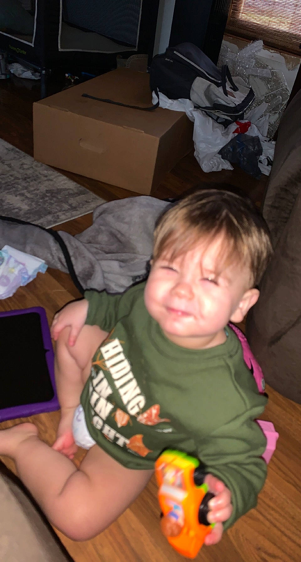 Ezekiel is registered to the contest to win money with this photo: baby, black, box, cheek, child, comfort, finger, fun, hand, head, iris, lap, mouth, nail, person, shipping_box, sitting, t_shirt, tablet_computer, thumb