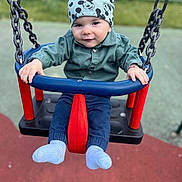 Andrei is registered to the contest to win money with this photo: baby, child, swing, playground, hat, mickey_mouse, clothing, blue, red, outdoor, fun, smile, person, toy, seat, chain, park, cute, happy, infant