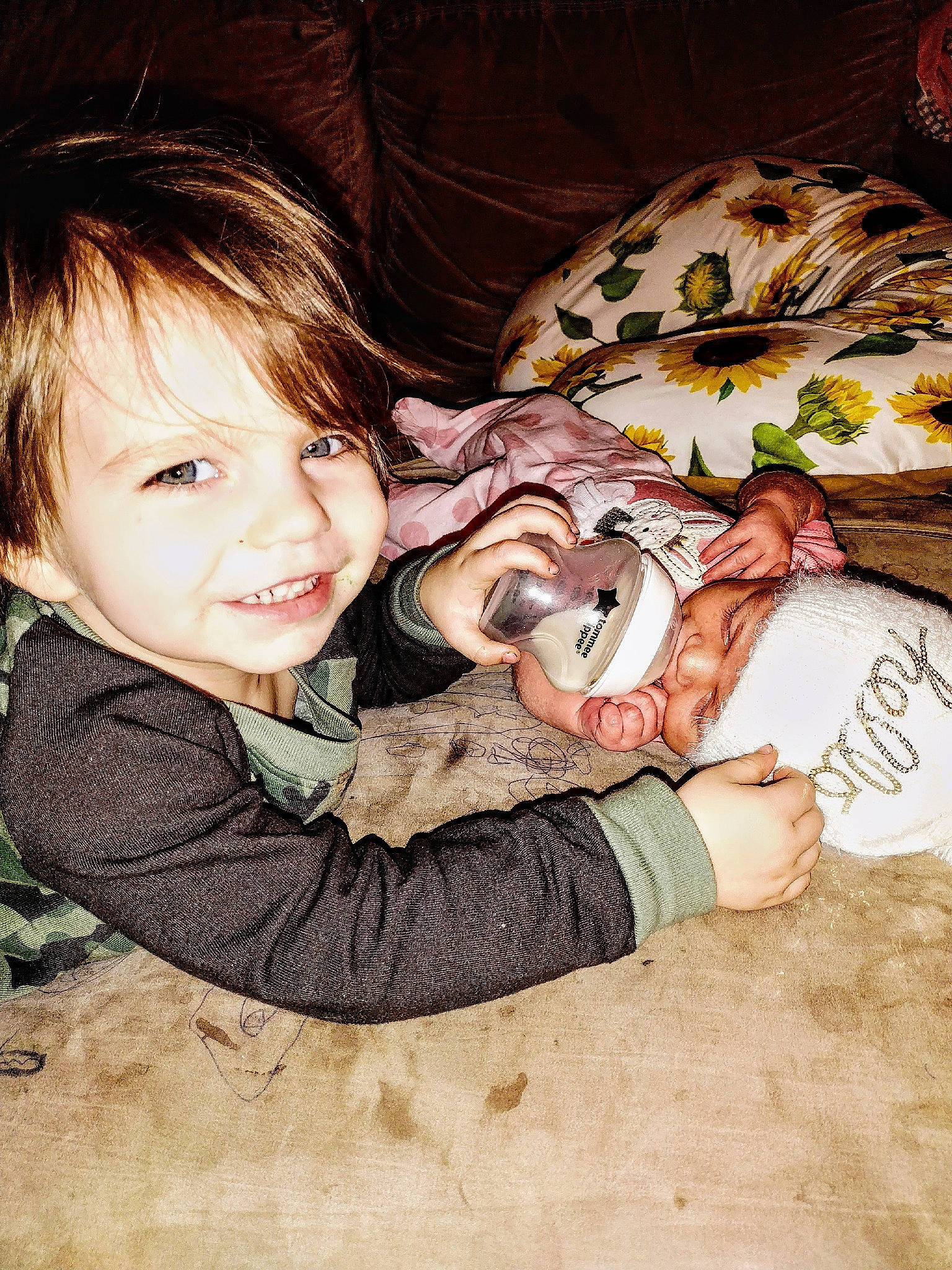 Kepha is registered to the contest to win money with this photo: baby_toddler_clothing, brown_hair, cheek, child, comfort, finger, fun, gesture, hairstyle, happy, iris, mammal, pattern, people_in_nature, person, sitting, skin, sleeve, smile, toddler