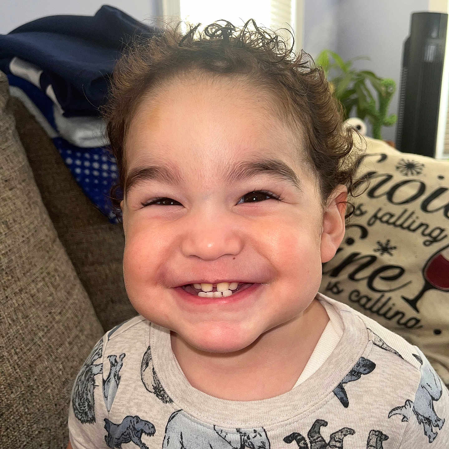 Jayziah joined the competition — help win amazing prizes! baby, blanket, bright, child, clothing, couch, cozy, curly_hair, cute, elephant_print, face, happy, home, indoor, person, pillow, portrait, smile, toddler, zebra_print