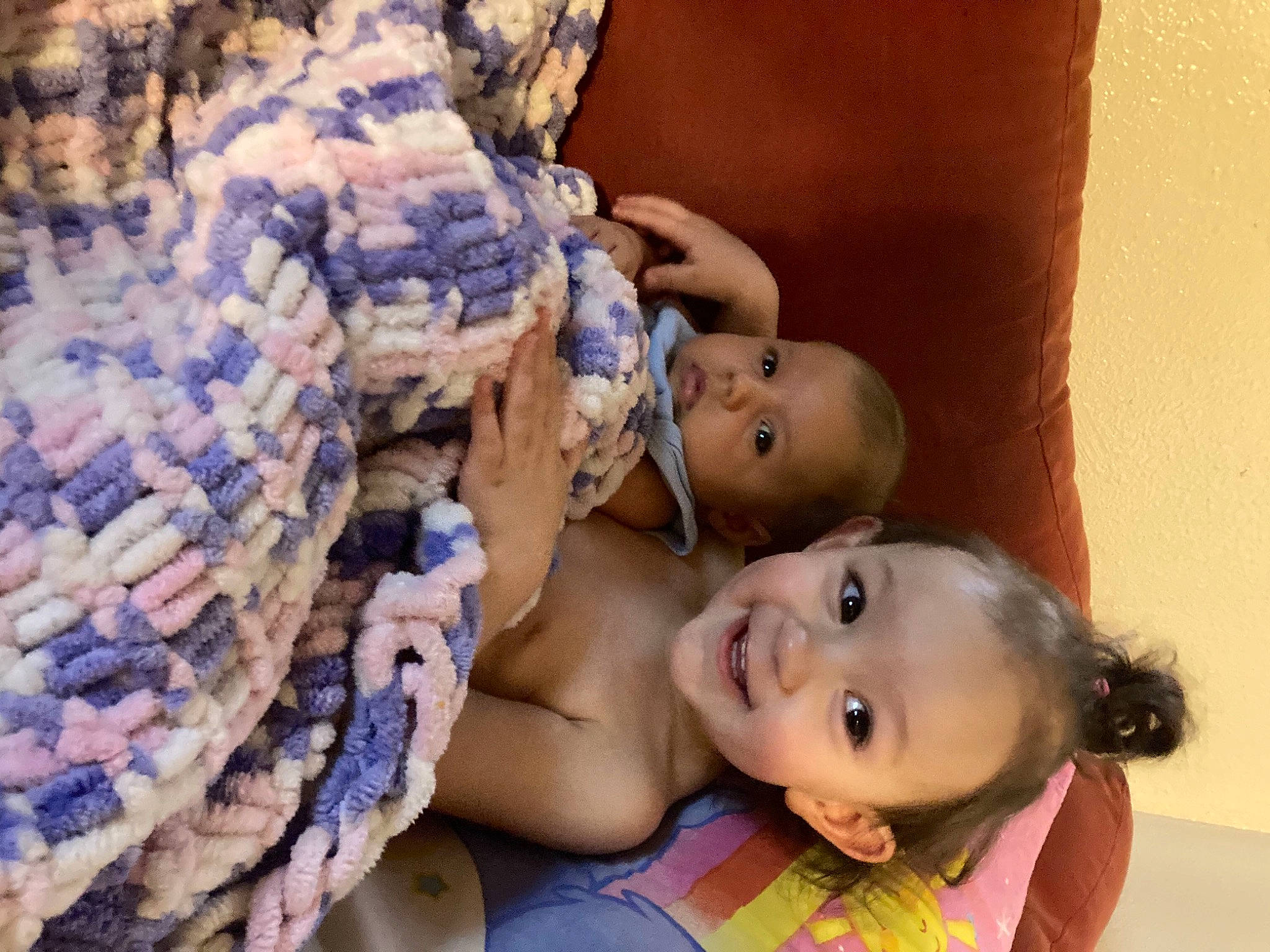 Byron is registered to the contest to win money with this photo: abdomen, baby, baby_products, baby_toddler_clothing, cheek, child, couch, doll, happy, iris, jewellery, joy, linens, lip, pattern, person, sitting, skin, smile, textile