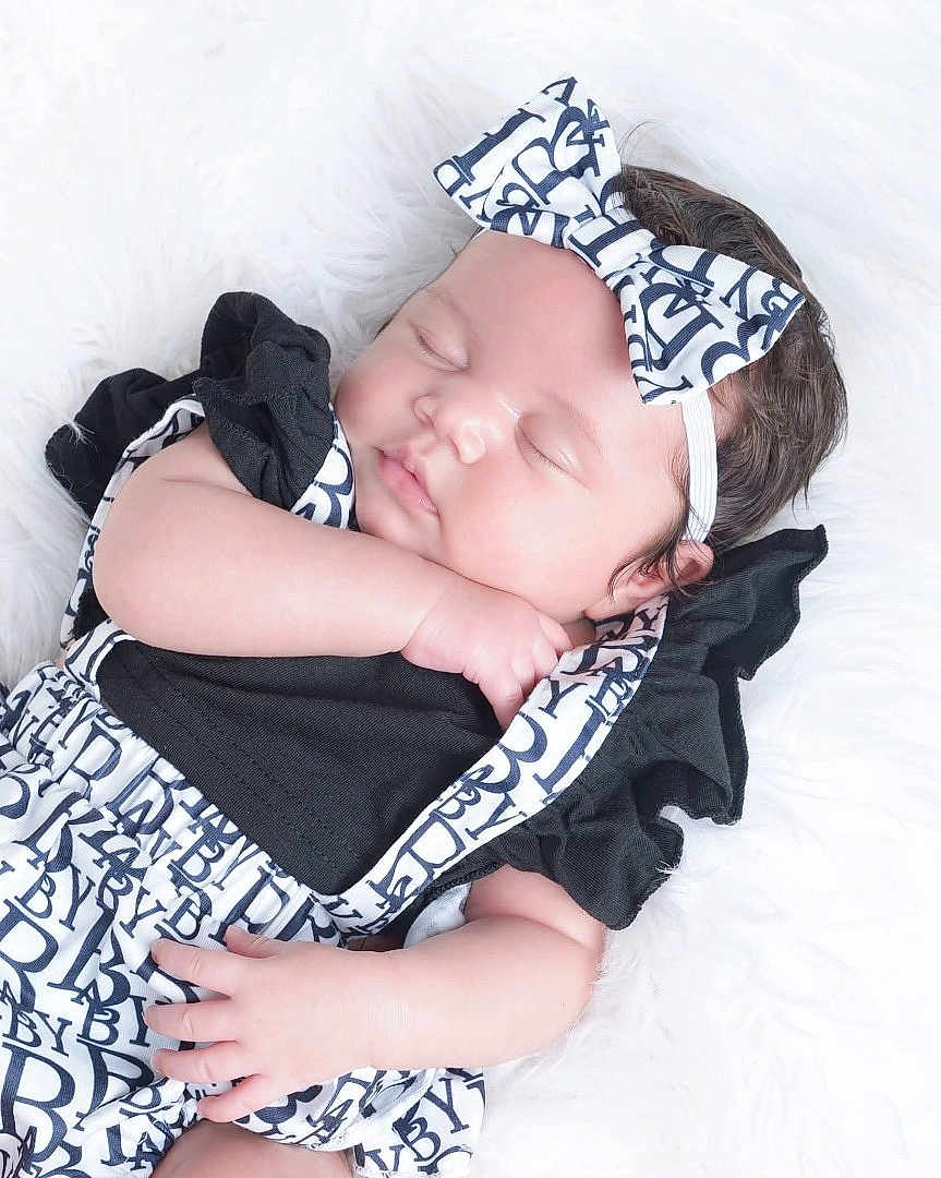 Jaliyah joined the competition — help win amazing prizes! adorable, baby, black_clothing, bow, child, closed_eyes, cute, face, fashion, fluffy, hand, headband, infant, newborn, peaceful, portrait, resting, sleeping, soft_texture, white_background