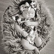 Jaliyah joined the competition — help win amazing prizes! baby, infant, sleeping, headband, bow, floral_outfit, fur_bed, cozy, portrait, black_and_white, peaceful, cute, toddler, child, soft_texture, wooden_floor, resting, adorable, small_hands, small_feet