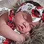 baby, sleeping, headband, floral_pattern, infant, peaceful, closeup, soft_texture, cuteness, adorable, skin, face, hand, resting, child, newborn, portrait, cozy, fabric, relaxation