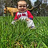 baby, grass, dog, outdoor, smiling, child, nature, sky, trees, puppy, animal, playful, happy, greenery, yard, pet, sunlight, cute, young_child, sitting