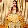 Alyssa a rejoint le concours — aidez-le/la à gagner de superbes lots ! child, girl, princess_dress, golden_gown, smiling, portrait, indoor, red_carpet, curtains, decorative, young, fashion, costume, face_paint, long_hair, pose, elegant, event, celebration, happy