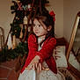 Alyssa participe au concours pour gagner de l'argent avec cette photo : child, girl, red_cardigan, white_dress, rocking_horse, holiday_decor, christmas_tree, garland, mirror, earrings, indoor, carpet, wooden_floor, toy, holiday_lighting, portrait, decorations, festive, warm_lighting, holiday_season