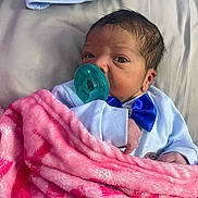 Orion joined the competition — help win amazing prizes! baby, newborn, infant, green_pacifier, pink_blanket, blue_bow, beanie_hat, bedding, portrait, close_up, clothing, hand, hair, face, eyes_open, cozy, bed, skin, hospital_blanket, adorable