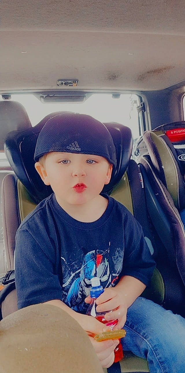 Tristan is registered to the contest to win money with this photo: auto_part, automotive_design, automotive_exterior, baseball_cap, cap, car_seat, car_seat_cover, cool, electric_blue, family_car, hat, head_restraint, headwear, motor_vehicle, person, personal_luxury_car, steering_wheel, t_shirt, toddler, travel