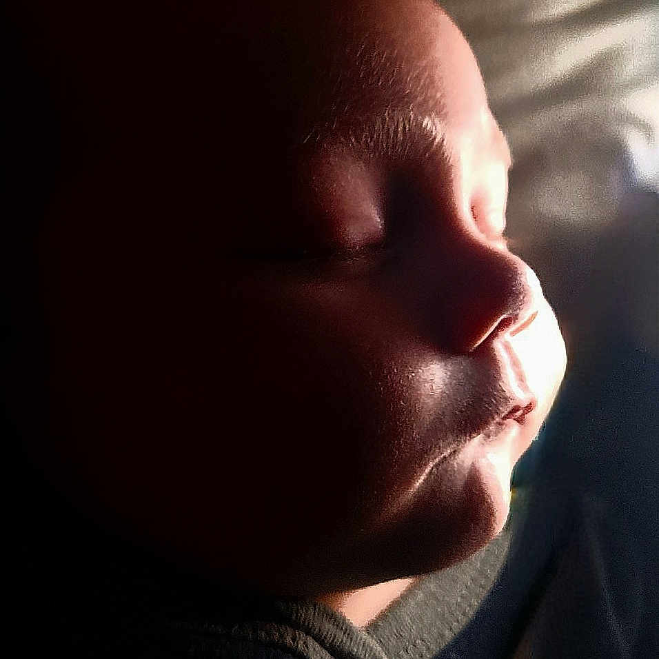 Levi joined the competition — help win amazing prizes! baby, calm, child, closeup, dark_background, face, head, human, indoors, infant, newborn, peaceful, portrait, profile, quiet, resting, skin, sleeping, soft_light, warm_light