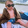 toddler, child, beach, sunglasses, blanket, sand, cloudy_sky, shorts, summer, outdoor, vacation, relaxing, cute, baby, sun_protection, dunes, blue_sky, casual, portrait, sitting